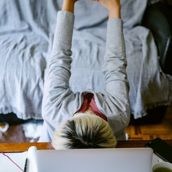Person stretching gently at an office desk